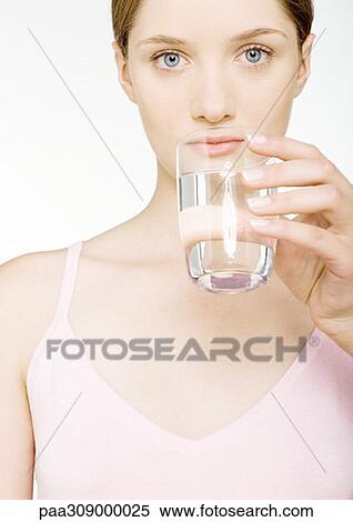 Stock Photography - Young woman drinking glass of water. Fotosearch