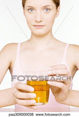 Young woman holding out glass of apple juice View Large Photo Image Stock Photo - Young woman holding out glass of apple juice. Fotosearch