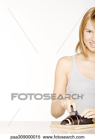 Young woman slicing eggplant View Large Photo Image Stock Photography - Young woman slicing eggplant. Fotosearch
