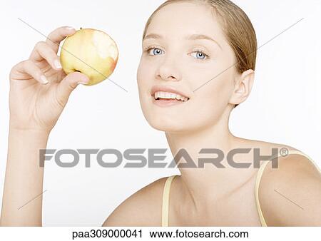 Young woman with apple View Large Photo Image Stock Image - Young woman with apple. Fotosearch