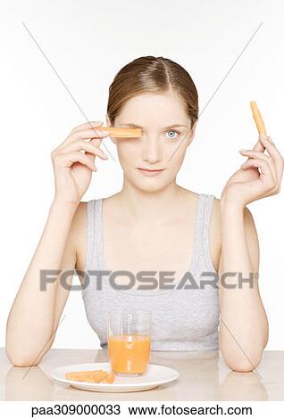 Young woman with carrot sticks and carrot juice View Large Photo Image Stock Image - Young woman with carrot sticks and carrot juice. Fotosearch