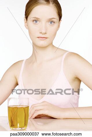 Young woman with glass of apple juice View Large Photo Image Stock Photo - Young woman with glass of apple juice. Fotosearch
