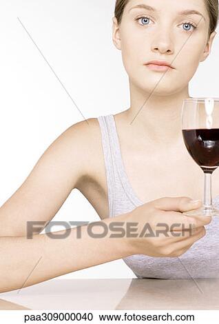 Young woman with glass of wine View Large Photo Image Stock Image - Young woman with glass of wine. Fotosearch