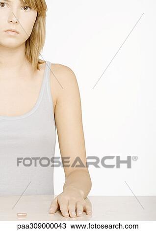 Young woman with pill View Large Photo Image Stock Image - Young woman with pill. Fotosearch
