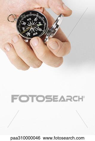 Hand holding compass View Large Photo Image Stock Photograph - Hand holding compass. Fotosearch