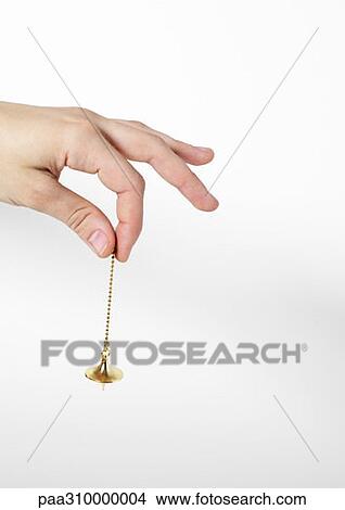 Hand holding pendulum View Large Photo Image Picture - Hand holding pendulum. Fotosearch
