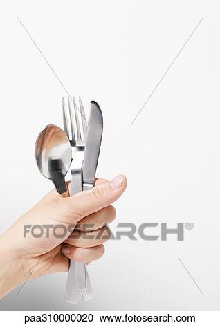 Hand holding silverware View Large Photo Image Stock Image - Hand holding silverware. Fotosearch