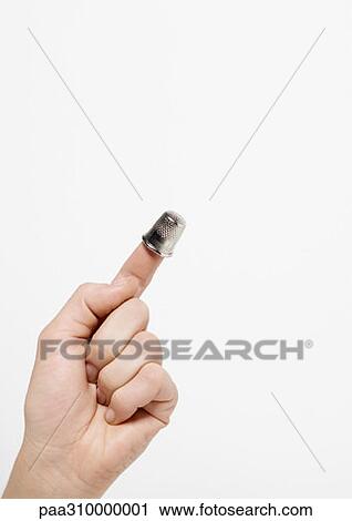 Hand with thimble on forefinger View Large Photo Image Stock Image - Hand with thimble on forefinger. Fotosearch