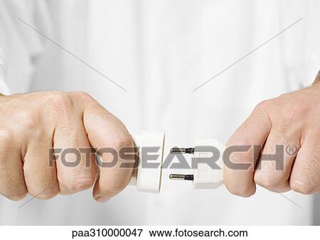 Hands plugging in electrical cord View Large Photo Image Stock Photo - Hands plugging in electrical cord. Fotosearch