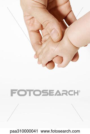 Man holding baby's hand View Large Photo Image Stock Image - Man holding baby's hand. Fotosearch