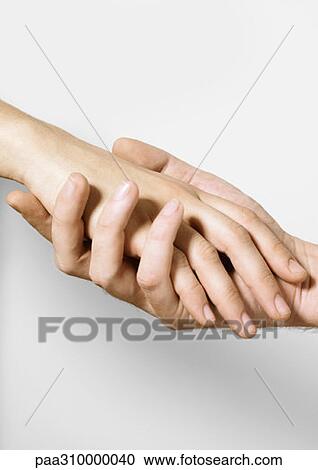 Stock Image - Man holding woman's hand. Fotosearch