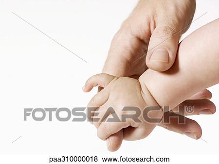 Man's hand holding baby's hand View Large Photo Image Stock Photo - Man's hand holding baby's hand. Fotosearch
