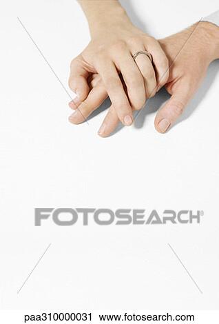 Woman wearing wedding ring clasping man's hand View Large Photo Image Stock Image - Woman wearing wedding ring clasping man's hand. Fotosearch