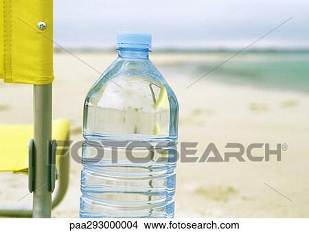 Bottle of water on beach View Large Photo Image Picture - Bottle of water on beach. Fotosearch