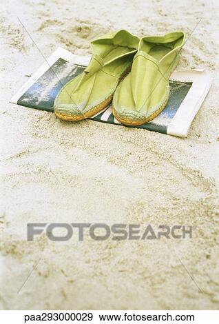 Espadrilles on newspaper on beach View Large Photo Image Stock Photo - Espadrilles on newspaper on beach. Fotosearch