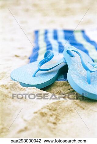 Flipflops and beach towel on beach View Large Photo Image Stock Image - Flipflops and beach towel on beach. Fotosearch