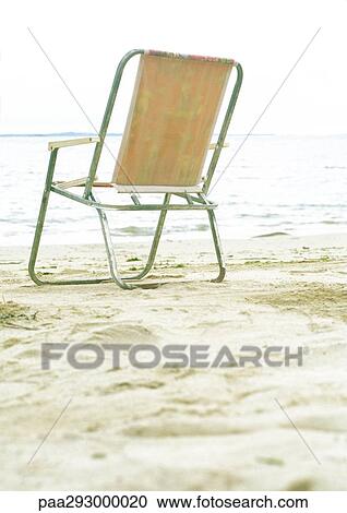 Folding chair on beach View Large Photo Image Stock Image - Folding chair on beach. Fotosearch
