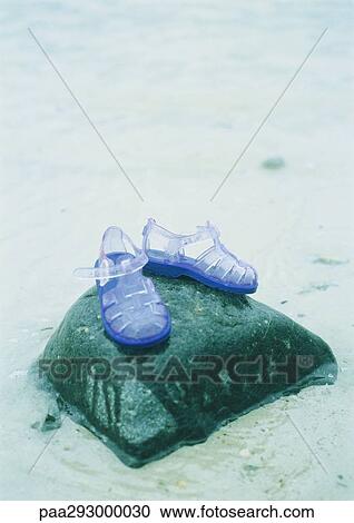 Jelly shoes on rock View Large Photo Image Stock Image - Jelly shoes on rock. Fotosearch