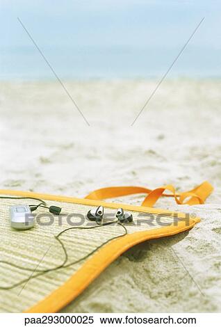 MP3 player on beach mat View Large Photo Image Stock Photography - MP3 player on beach mat. Fotosearch