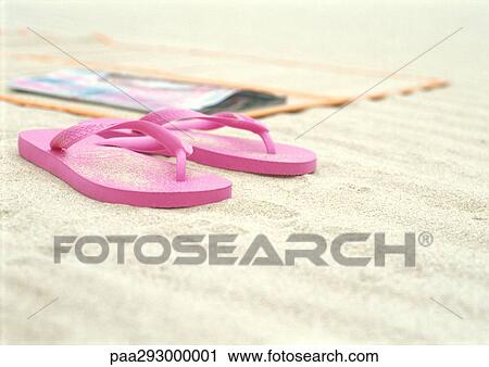 Pink flipflops next to beach mat on beach View Large Photo Image Stock Image - Pink flipflops next to beach mat on beach. Fotosearch
