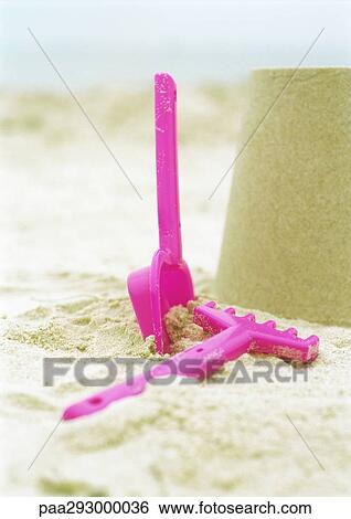 Sand shovel and rake on beach View Large Photo Image Stock Photograph - Sand shovel and rake on beach. Fotosearch