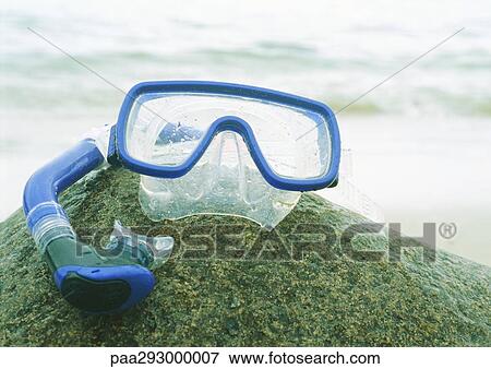 Snorkeling mask and snorkel on rock View Large Photo Image Stock Photo - Snorkeling mask and snorkel on rock. Fotosearch
