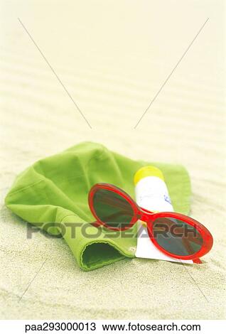 Sunglasses, sunscreen and sun hat on beach View Large Photo Image Stock Image - Sunglasses, sunscreen and sun hat on beach. Fotosearch