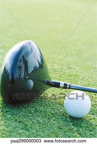Stock Image - Golf ball and club, close-up. Fotosearch