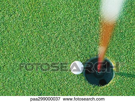 Golf ball at edge of hole, view from directly above View Large Photo Image Stock Photo - Golf ball at edge of hole, view from directly above. Fotosearch