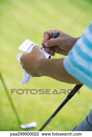 Stock Image - Golfer keeping score, close-up. Fotosearch