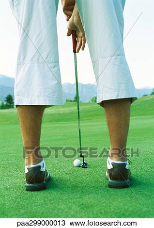Golfer preparing to swing, low section, rear view View Large Photo Image Stock Image - Golfer preparing to swing, low section, rear view. Fotosearch