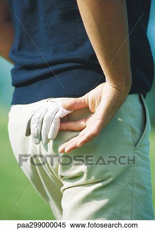 Golfer taking glove from back pocket, close-up View Large Photo Image Stock Photography - Golfer taking glove from back pocket, close-up. Fotosearch