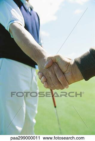 Golfers shaking hands View Large Photo Image Stock Image - Golfers shaking hands. Fotosearch
