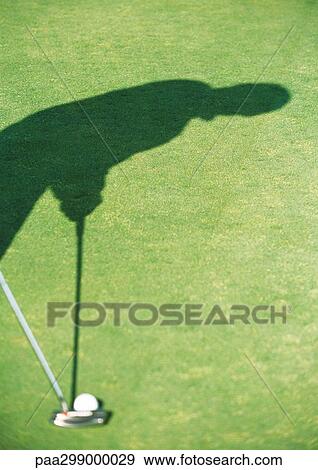 Stock Photo - Shadow of golfer putting. Fotosearch
