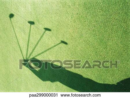 Shadow of golfer swinging, motion study View Large Photo Image Stock Image - Shadow of golfer swinging, motion study. Fotosearch