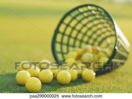 Spilled basket of yellow golf balls, close-up View Large Photo Image Stock Photography - Spilled basket of yellow golf balls, close-up. Fotosearch