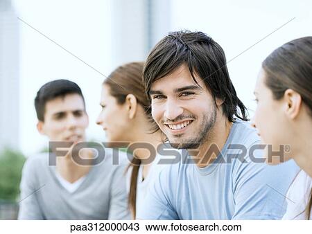 Group of young adults in urban park View Large Photo Image Stock Image - Group of young adults in urban park. Fotosearch
