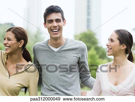Three friends laughing in urban park View Large Photo Image Stock Photo - Three friends laughing in urban park. Fotosearch
