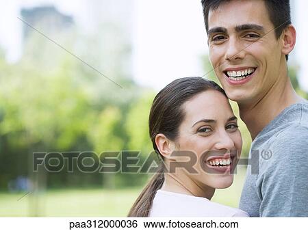 Young couple in urban park, close-up View Large Photo Image Stock Photograph - Young couple in urban park, close-up. Fotosearch