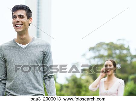 Young man and woman in urban park View Large Photo Image Stock Image - Young man and woman in urban park. Fotosearch