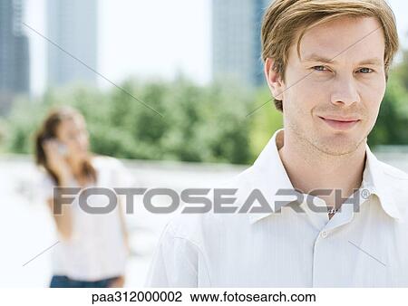 Young man in urban park, portrait View Large Photo Image Stock Image - Young man in urban park, portrait. Fotosearch