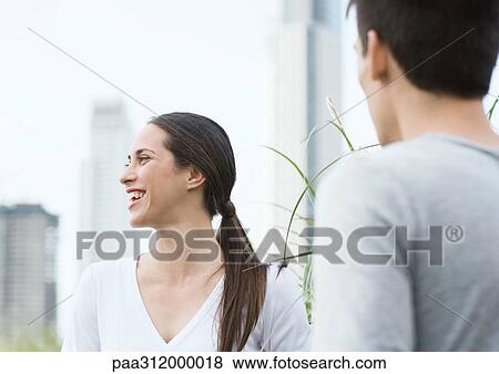 Young woman laughing, with young man View Large Photo Image Stock Photo - Young woman laughing, with young man. Fotosearch