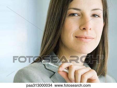 Picture - Businesswoman holding pen, close-up, portrait. Fotosearch