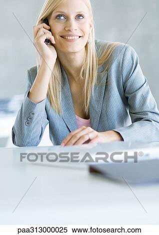 Businesswoman using cell phone, smiling View Large Photo Image Stock Photography - Businesswoman using cell phone, smiling. Fotosearch
