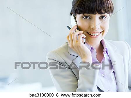 Businesswoman using cell phone View Large Photo Image Stock Photo - Businesswoman using cell phone. Fotosearch