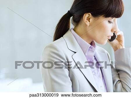 Businesswoman using cell phone View Large Photo Image Stock Photo - Businesswoman using cell phone. Fotosearch