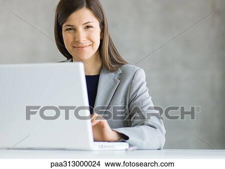 Businesswoman using laptop computer View Large Photo Image Picture - Businesswoman using laptop computer. Fotosearch