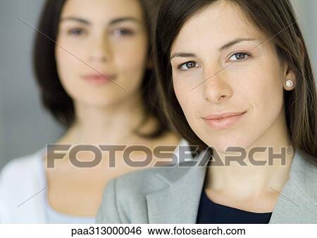 Businesswoman with co-worker, portrait View Large Photo Image Stock Photograph - Businesswoman with co-worker, portrait. Fotosearch