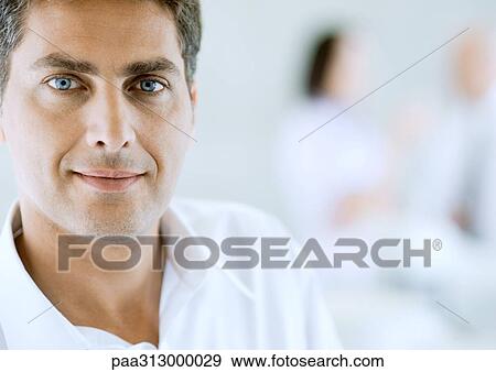 Man wearing white shirt with open collar, portrait View Large Photo Image Stock Photo - Man wearing white shirt with open collar, portrait. Fotosearch