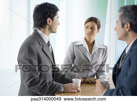 Stock Photo - Business colleagues having coffee break. Fotosearch